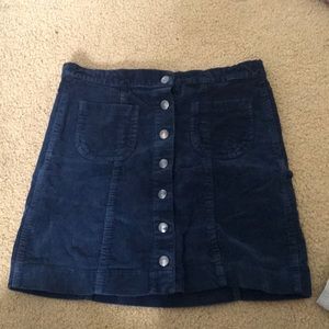 Courderoy navy blue skirt. It’s also stretchy. It will fit a medium waist.